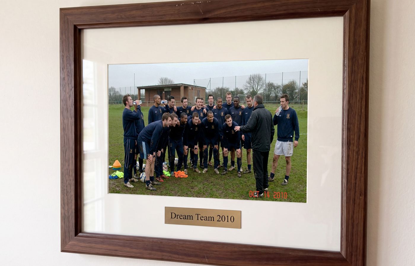 Framed university football team photo on the wall, Dream Team 2010